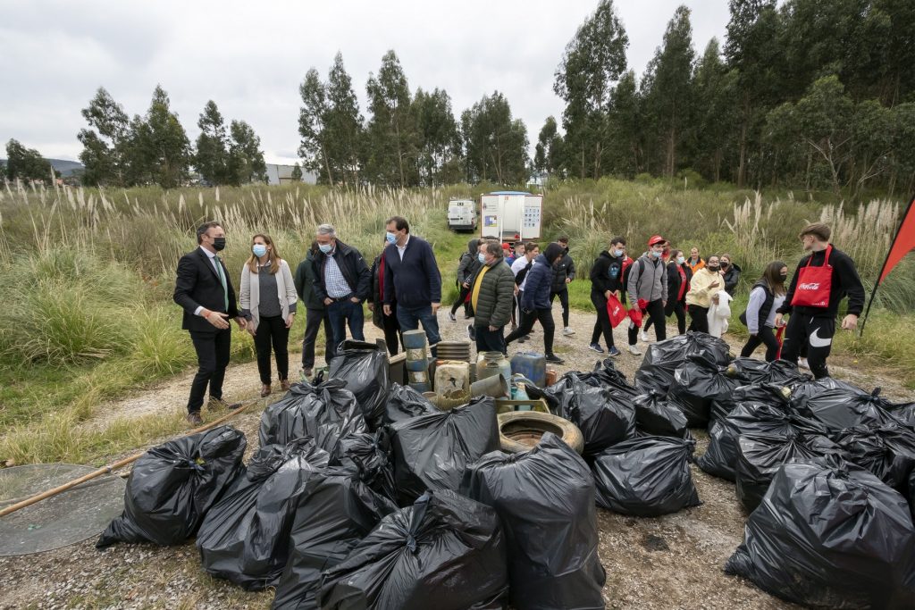 El consejero Guillermo Blanco junto a los voluntarios en la limpieza de la ría de Requejada