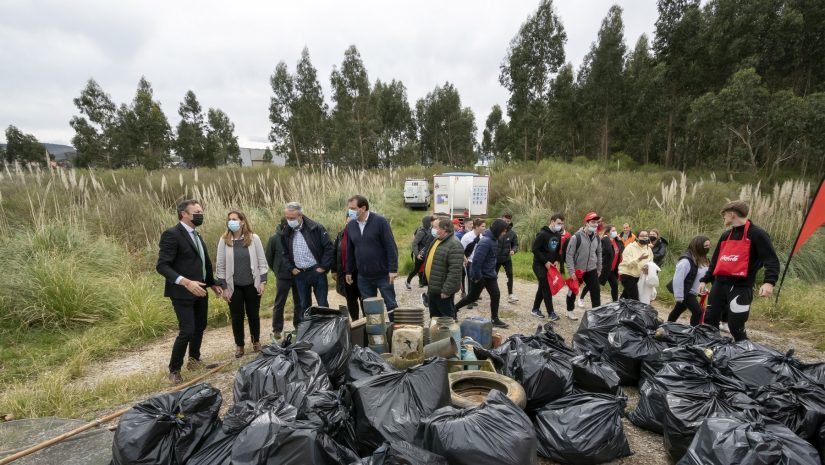 El consejero Guillermo Blanco junto a los voluntarios en la limpieza de la ría de Requejada