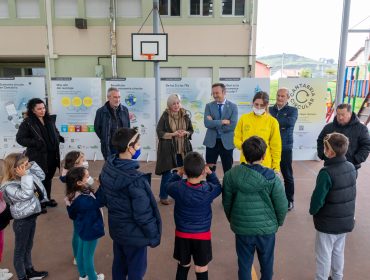 Consejero y alcaldesa junto a niños, vecinos y concejales que acudieron a la inauguración de la muestra